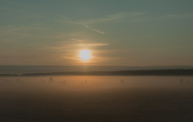 A summer sunrise with tender perl colors and mistic mist 