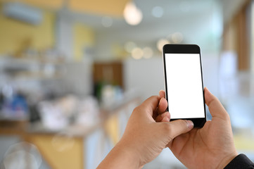 Mockup smartphone on man's hands with empty screen in cafe.