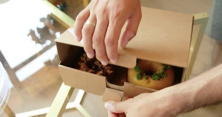 Delicious sweet colorful donuts in takeaway box