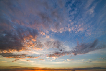 Dramatic sunset sky with orange clouds.