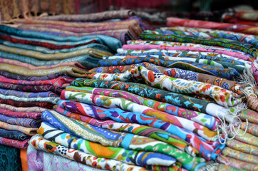 piles of colorful scarfes for sale at the asian bazar