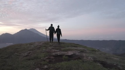 Tourists standing on top of hill
