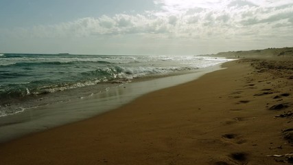 Seascape. Great waves breaking on sandy shore of stormy Mediterranean sea. Greece. 4K