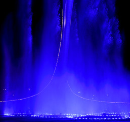 A dancing fountain of blue in the park