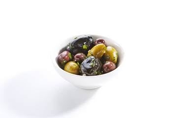 Delicious olive assorti marinated in oil closeup
