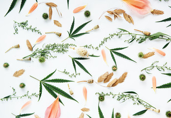 Floral pattern with wildflowers and green cannabis leaves.
