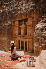 Young woman, exploring the sights of the ancient city of Petra in Jordan.