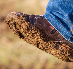 Dirt and soil on a man’s shoe in a park
