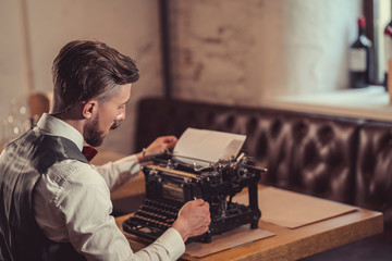 Young man with a retro typewriter