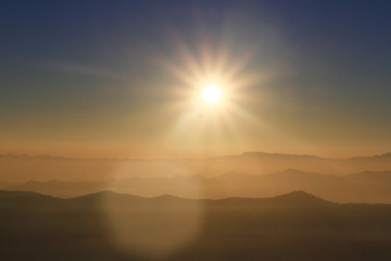 Beautiful Sunset and sunrise on sky and golden twilight time with mist and fog in valley of mountain layer