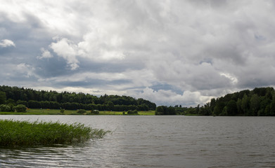Storm clouds over lake, dramatic sky.