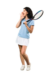 A full-length shot of a Young tennis player woman shouting with mouth wide open over isolated white background