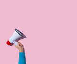 Person holding a megaphone with hard shadow
