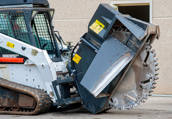 wreath with cones for drilling rock mounted on mini excavator'