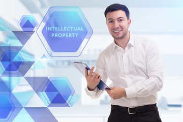 The concept of business, technology, the Internet and the network. A young entrepreneur working on a virtual screen of the future and sees the inscription: Intellectual property