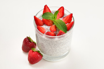 Chia pudding with strawberry and mint on a white background. Space for text or design.