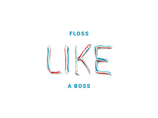 The phrase „floss like a boss“ written with  blue, red and white striped toothpaste, toothpaste...