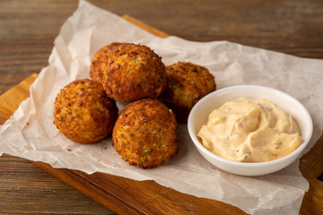 Falafel and white sauce on wood