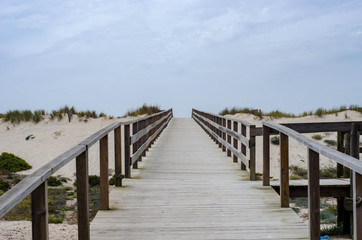 Obraz premium Wooden boardwalk path to the atlantic ocean beach in Costa Nova do prado, Portugal
