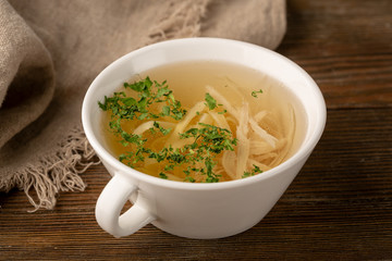 Bouillion with noodles and white meat close-up