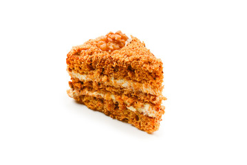 Peace of honey cake isolated on white background.