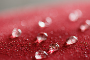 Rain  Water droplets on  a  red waterproof fabric