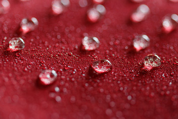  Water droplets on  a  jacket of red waterproof fabric