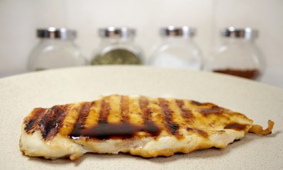 chicken steak on a plate with spices