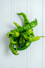 Creative layout with hot pepper and basil in on a white wooden background with copy space. Top view food. Eco vegetables without nitrates, GMO. Fresh Farm Products. Food photo background. Flat lay