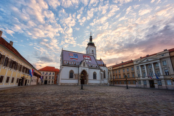 Church of St Mark (Crkva sv Marka) in Zagreb Old city with colourful tiled roof at sunrise. Scenic view of medieval architecture of the historical Upper town (Gradec or Gornij Grad) of Zagreb, Croatia - obrazy, fototapety, plakaty