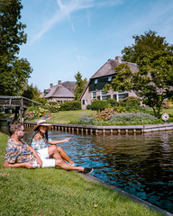 Giethoorn Netherlands, iew of typical houses of Giethoorn. The beautiful houses and gardening city is know as "Venice of the North".