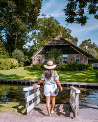 Giethoorn Netherlands, iew of typical houses of Giethoorn. The beautiful houses and gardening city is know as "Venice of the North".