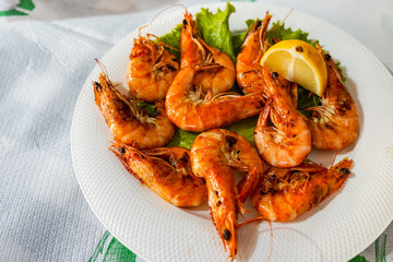prepared dish of tiger prawns on a plate in a seafood restaurant, close-up