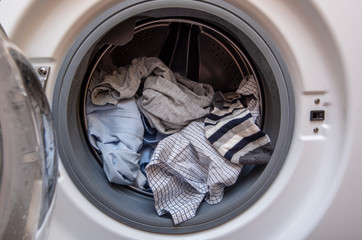 Washing Machine with opened Door and Dirty Clothes Before washing, machine full of dirty Clothes