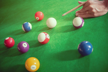 close up ofman playing a snooker or billiard in club.