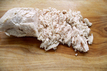 boiled chicken meat sliced on a board