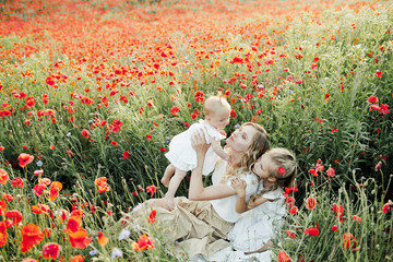 woman with her elder daughter look at a baby