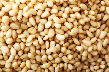 Background texture of shelled pine nuts. Cedar.