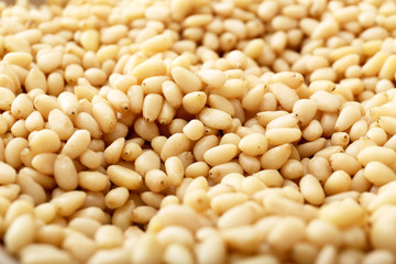 Background texture of shelled pine nuts. Cedar.