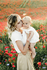 a woman looks at her baby, and woman's elder daughter looks at them