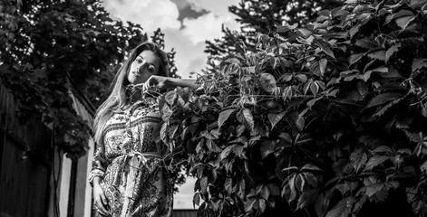 Fototapeta na wymiar Beautiful emotional black-white portrait of young woman outdoor.