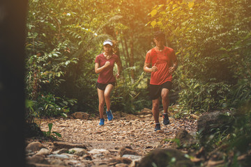 Runners. Young people  trail running on a mountain path. Adventure trail running on a mountain. Runners receive injuries from running trails on a mountain