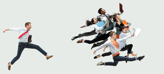 Happy office workers jumping and dancing in casual clothes or suit with folders on white. Ballet dancers. Business, start-up, working open-space, motion and action concept. Creative collage.