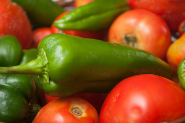 CLoseup of organic peppers and tomatoes stack