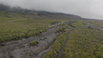 Motorcyclist traveling among mountains