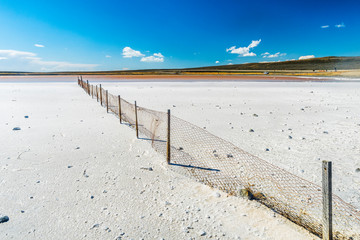 Old fence in a salt lake in Tierra del Fuego in Argentina