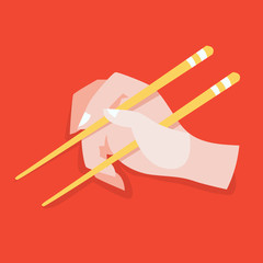 Hand hold chinese or japanese chopsticks. Eating asian food