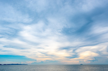 Blue sky and beautiful fluffy clouds in a sunny day over the sea.