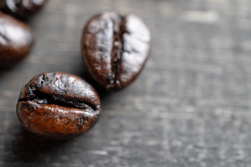 close up Coffee beans on wooden table. Copy space for text and content.