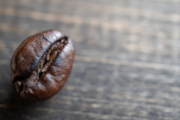 close up Coffee beans on wooden table. Copy space for text and content.